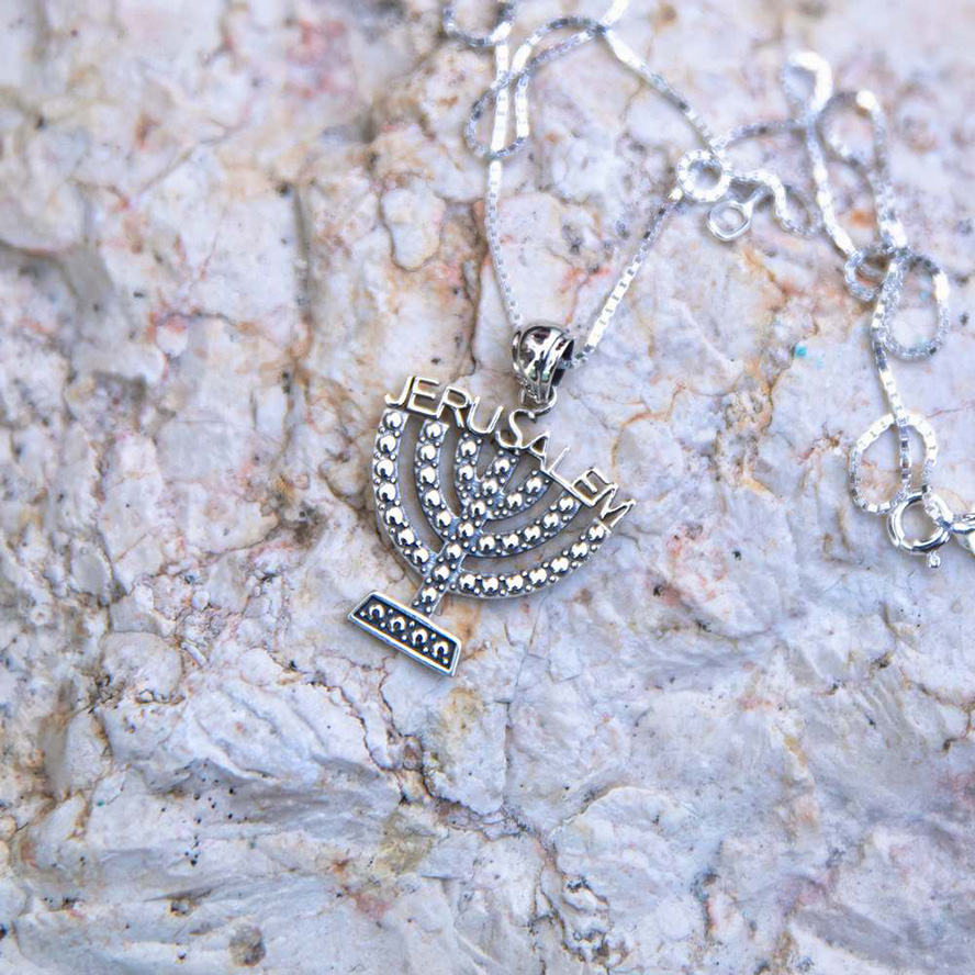Menorah with ‘Jerusalem’ Necklace in Sterling Silver – set on a rock